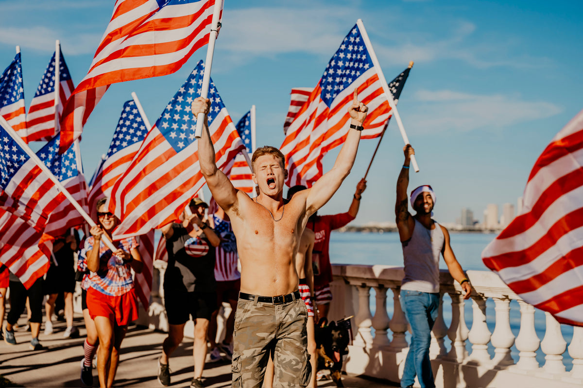 UNIFY community members carrying American flags together