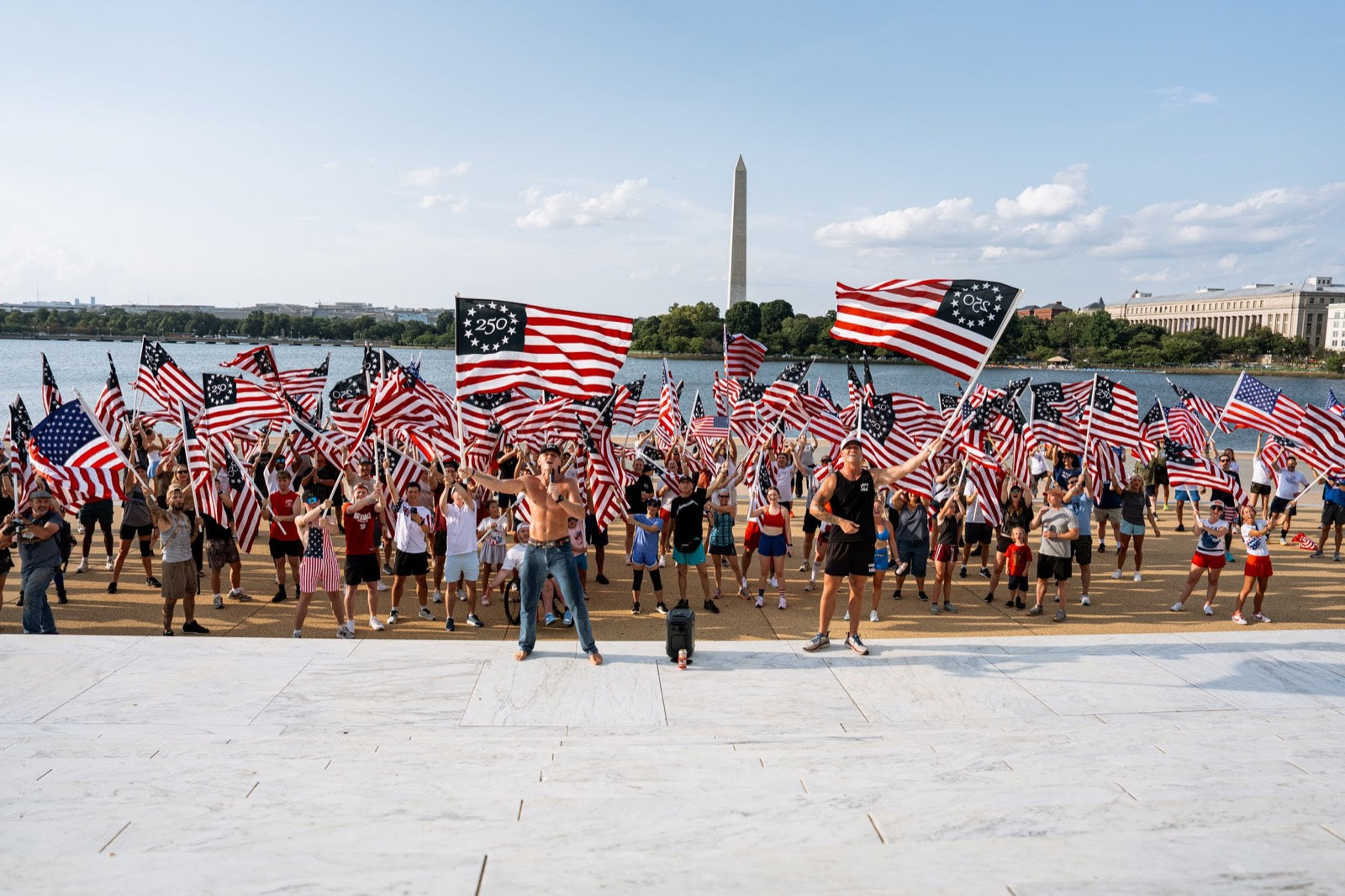 Teag and Kos with hundreds of people waving flags at the Jefferson Memorial in Washington, DC